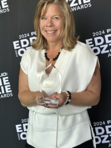 Nancy Glick holding Eddie Award.